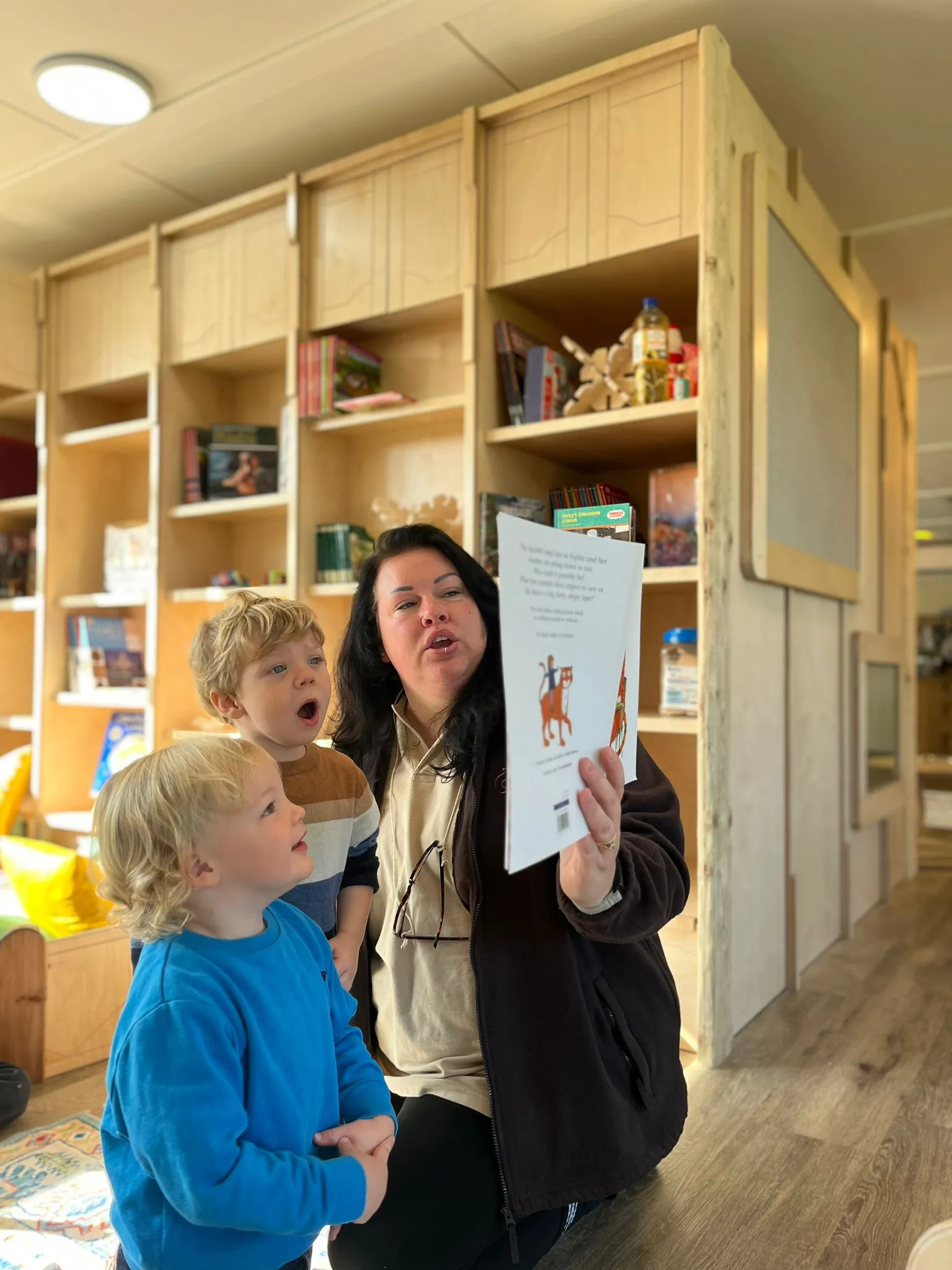 Image of a teacher and child reading.