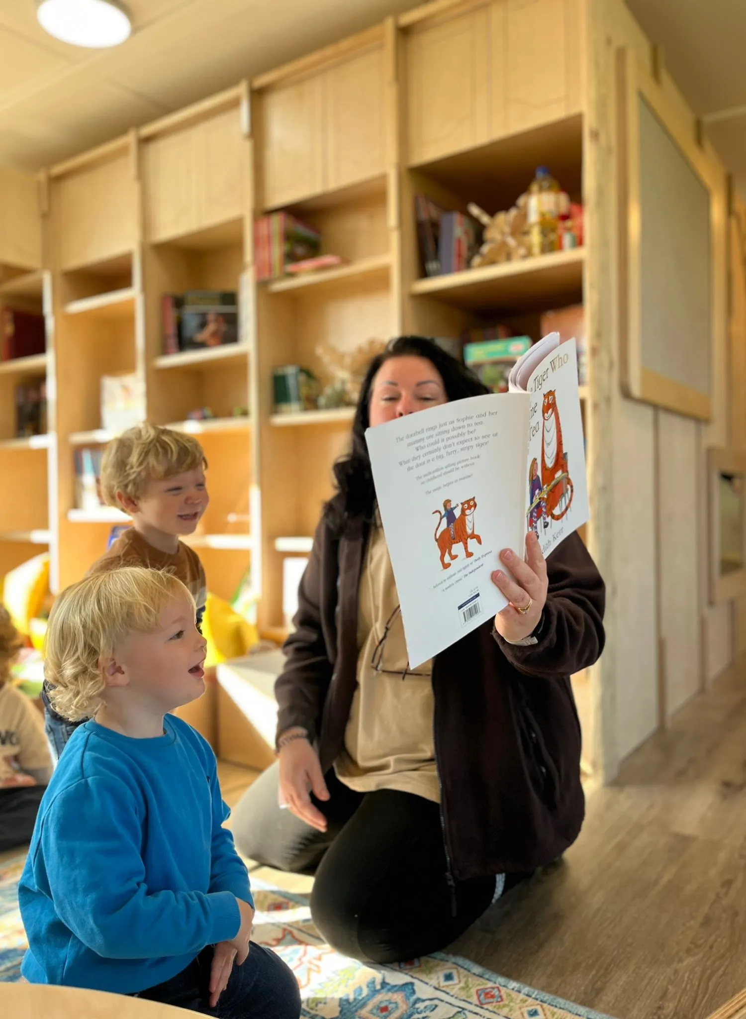 Image of a teacher and child reading.