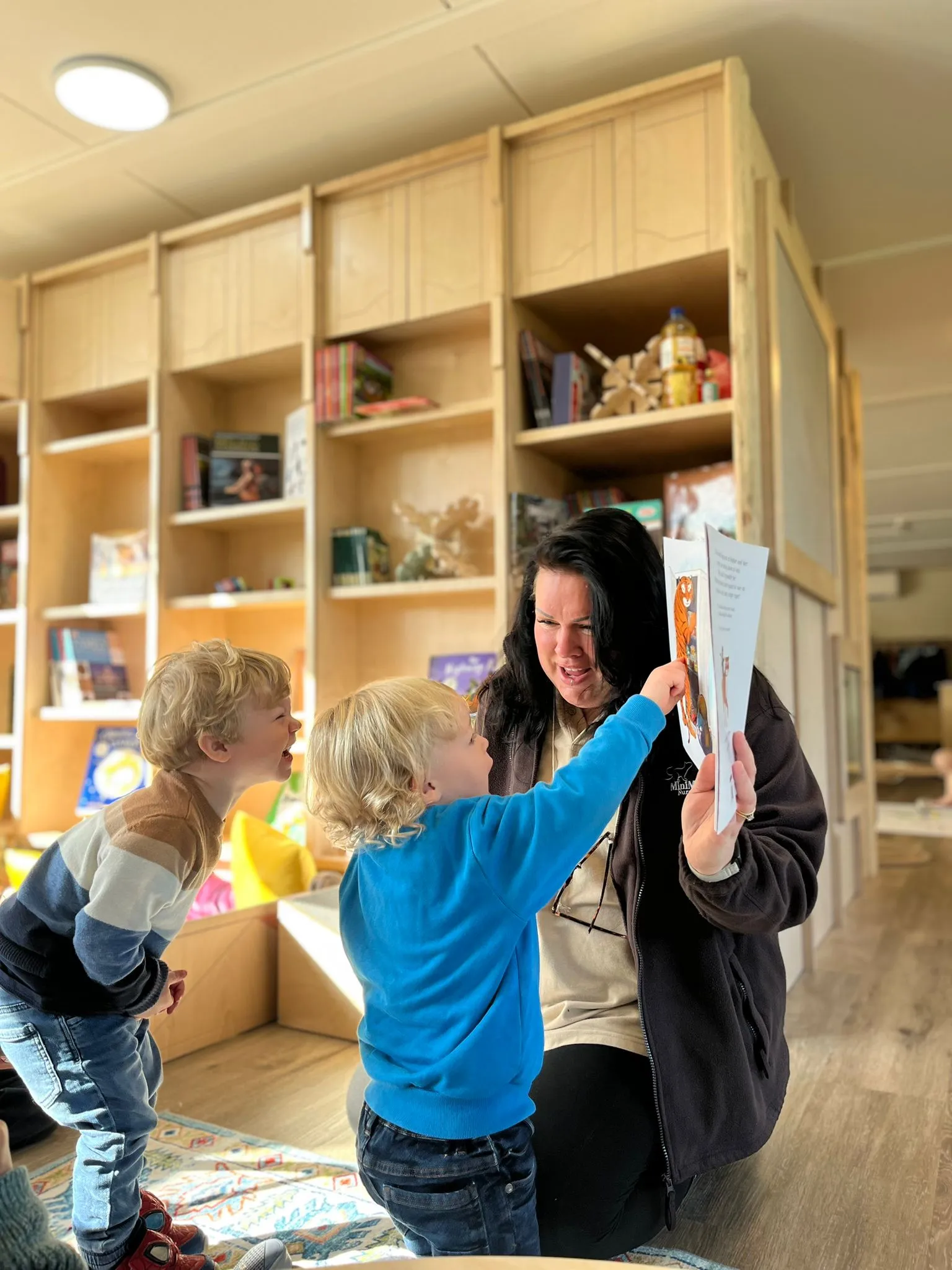 Image of a teacher and child reading.