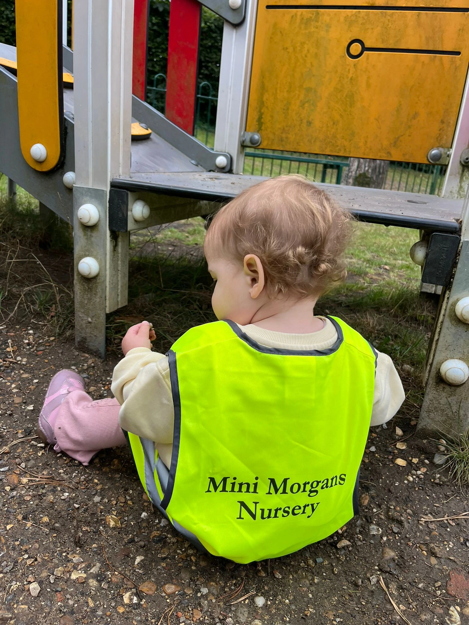 image of a child sitting on the ground.
